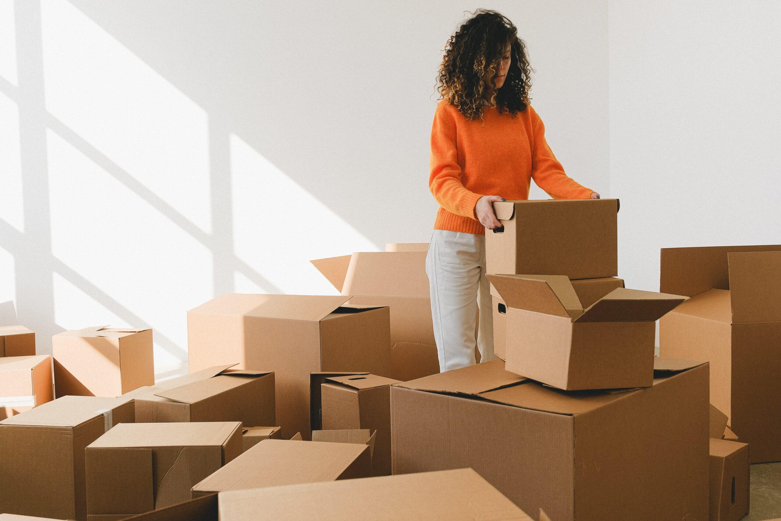 Woman packing moving boxes in a storage unit